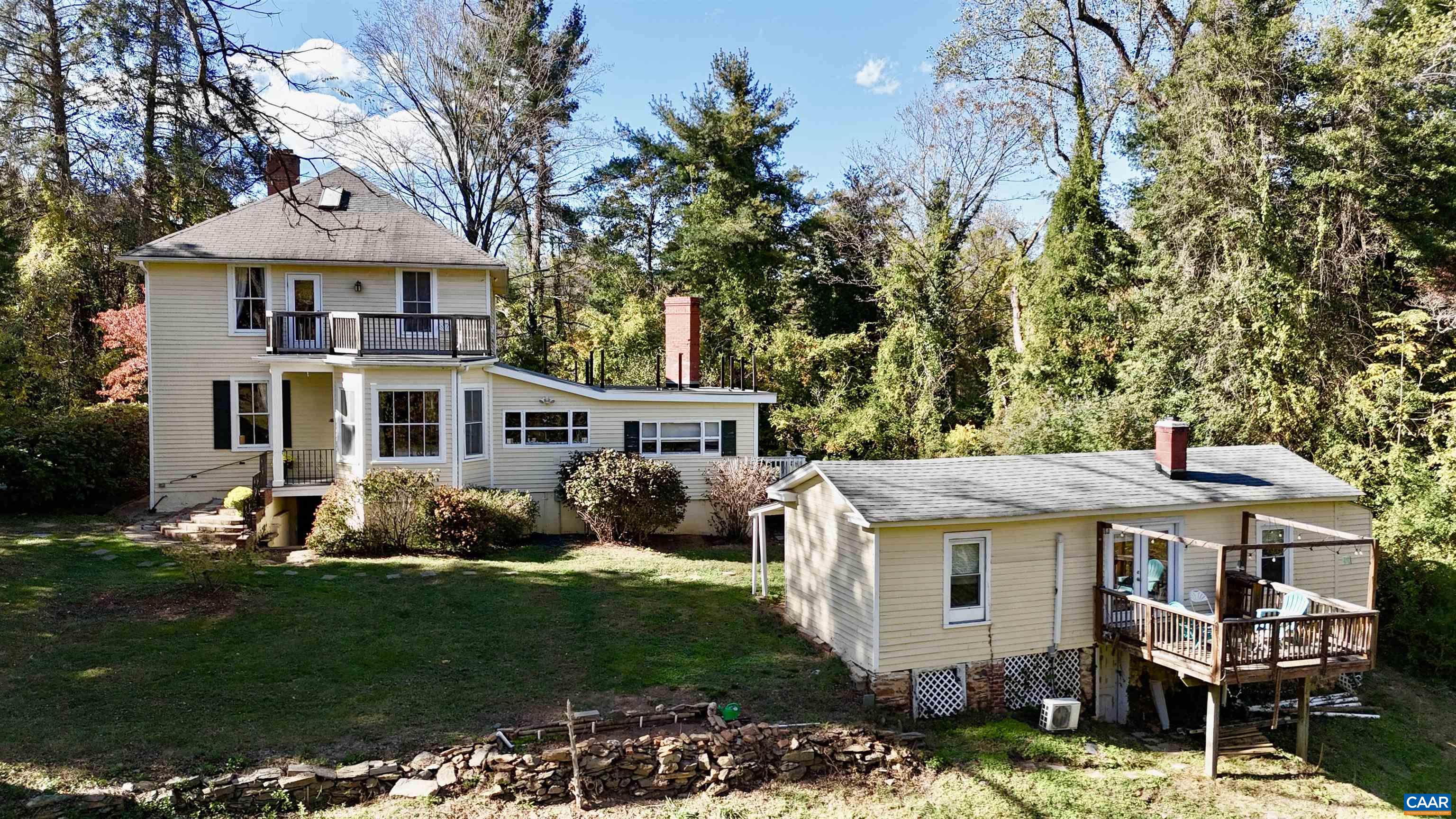 5515 L Gordonsville Road Keswick, VA 22947 - Photo 16 of 25 a front view of a house with a garden and trees