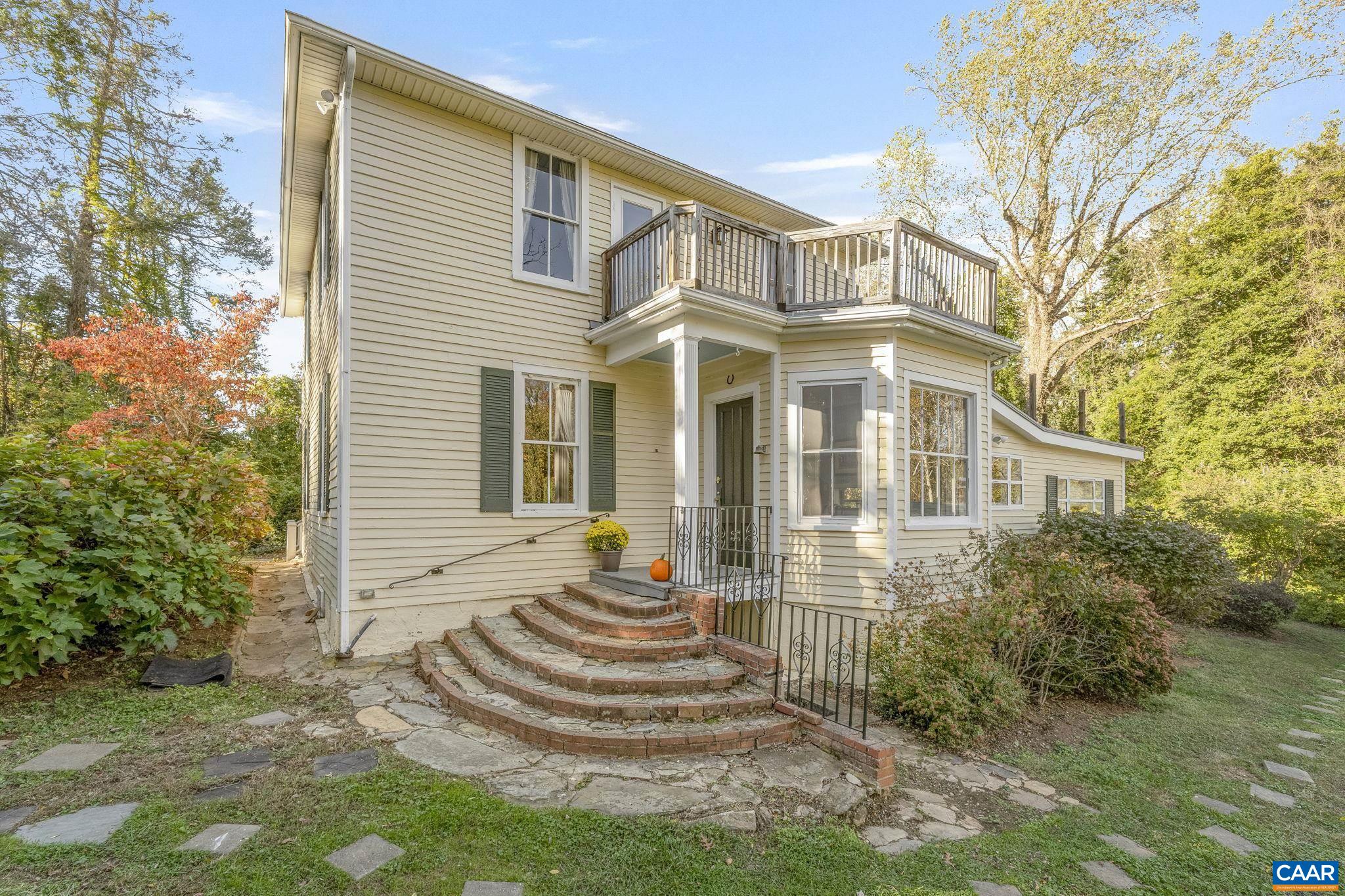 5515 L Gordonsville Road Keswick, VA 22947 - Photo 23 of 25 a front view of a house with a garden