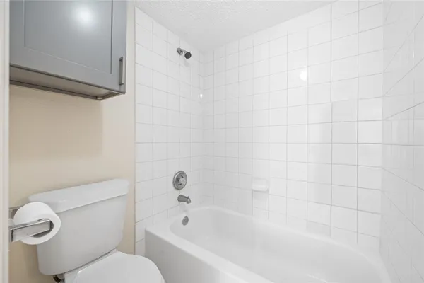 a white bath tub sitting next to a white toilet