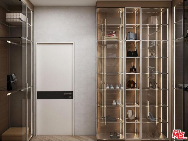 a view of walk in closet with empty racks