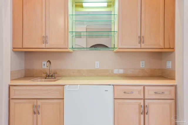 a kitchen with a sink stove and refrigerator
