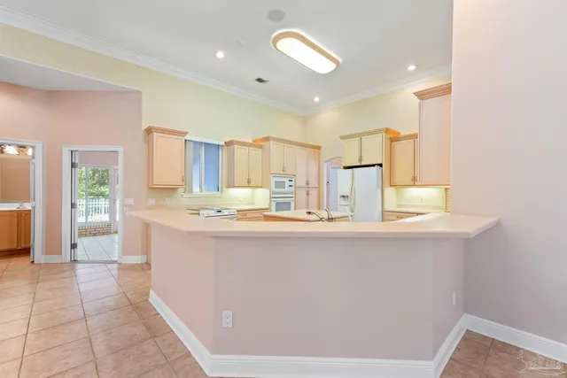 a view of a kitchen with a sink and refrigerator