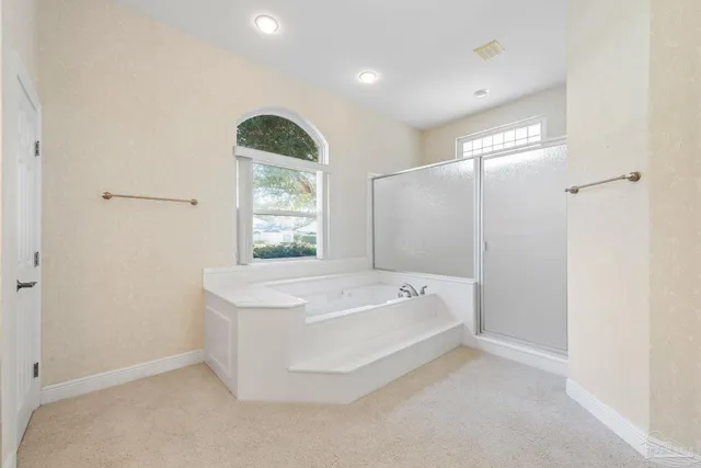 an empty room with a ceiling fan and a window