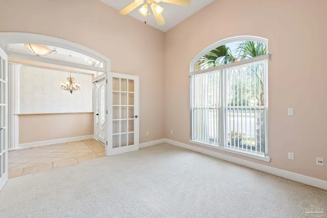 a view of a house with a swimming pool and large tree