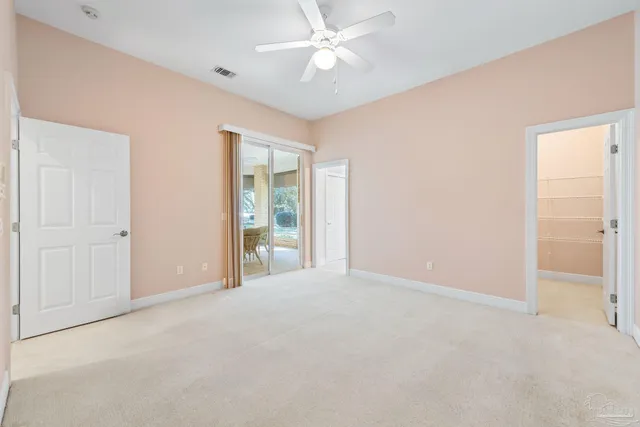 a dining room with chairs and large windows