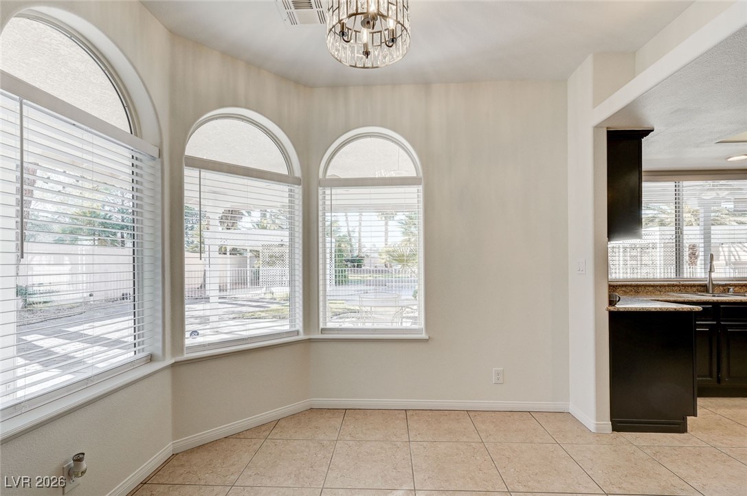 2955 El Camino Road Las Vegas, NV 89146 - Photo 24 of 99 Unfurnished dining area with light tile patterned floors and a chandelier