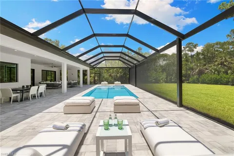 a view of swimming pool with seating space