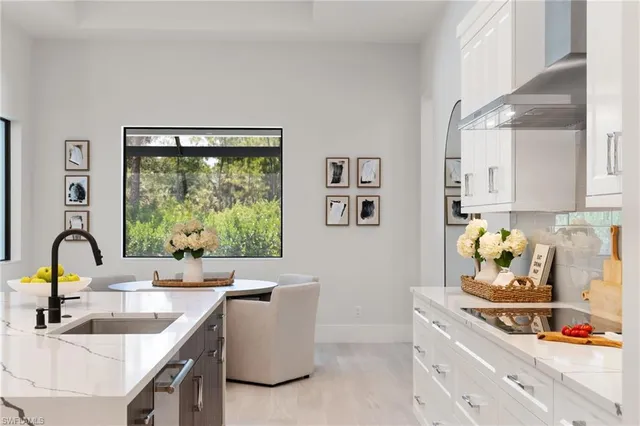 a kitchen with granite countertop a sink stove and cabinets