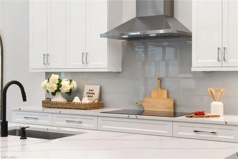 a kitchen with a stove and cabinets