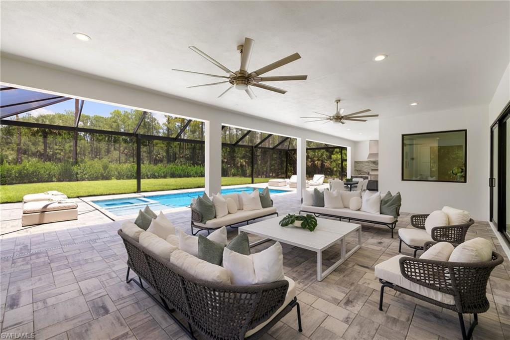 4751 1st Avenue Southwest Naples, FL 34119 - Photo 15 of 36 a living room with furniture and a large window