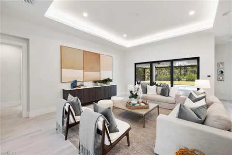a living room with furniture large window and a couch