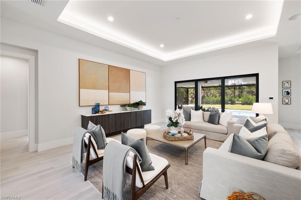 4751 1st Avenue Southwest Naples, FL 34119 - Photo 20 of 36 a living room with furniture and a large window