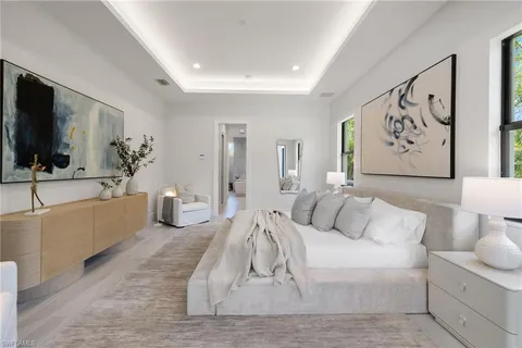 a spacious bathroom with double vanity sink a two mirror a bathtub and a toilet