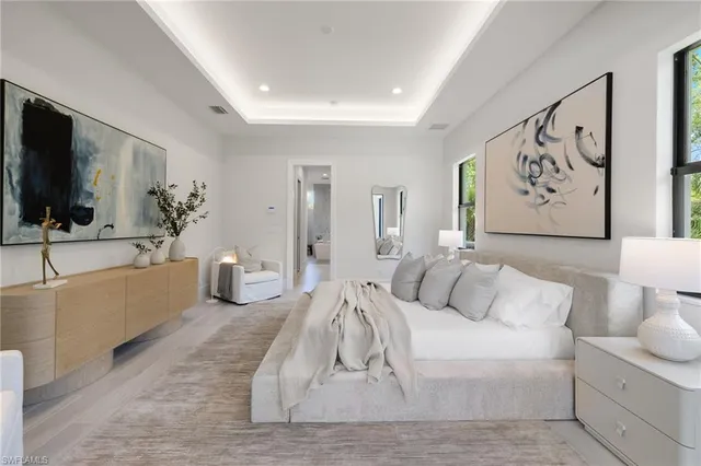 a spacious bathroom with double vanity sink a two mirror a bathtub and a toilet