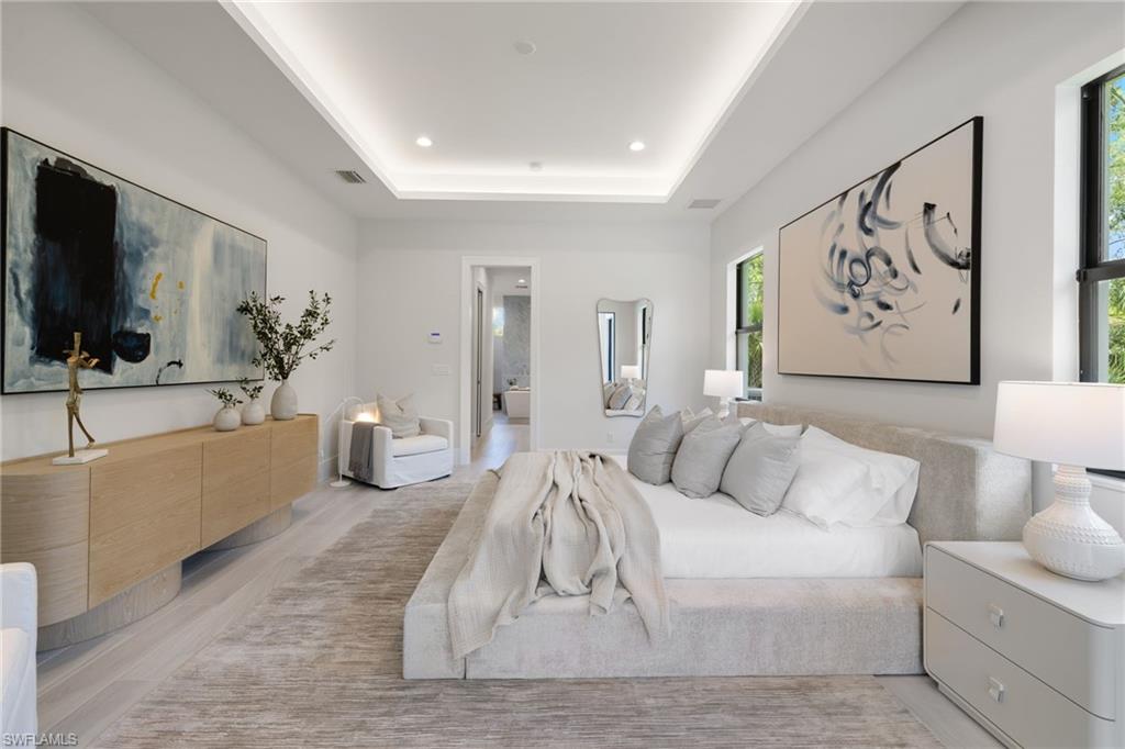 4751 1st Avenue Southwest Naples, FL 34119 - Photo 22 of 36 a living room with furniture and a flat screen tv