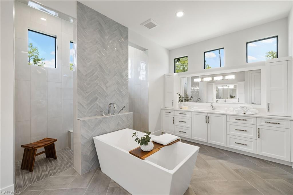 4751 1st Avenue Southwest Naples, FL 34119 - Photo 24 of 36 a bathroom with a sink a toilet and a mirror