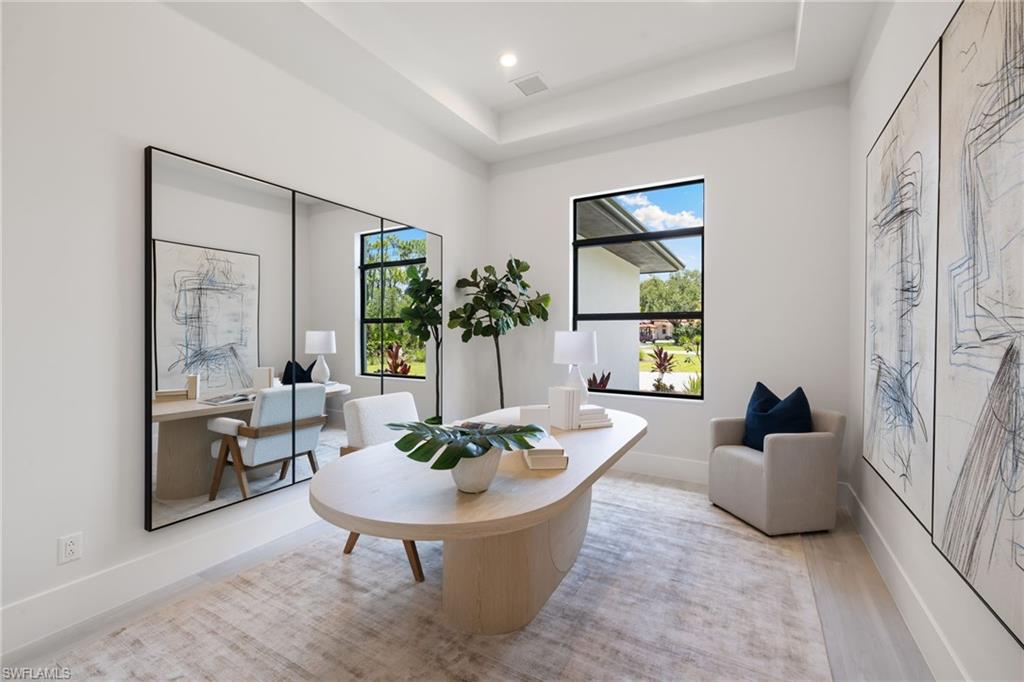 4751 1st Avenue Southwest Naples, FL 34119 - Photo 27 of 36 a living room with furniture and a potted plant