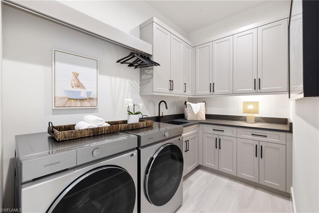 4751 1st Avenue Southwest Naples, FL 34119 - Photo 29 of 36 a kitchen with cabinets and washer