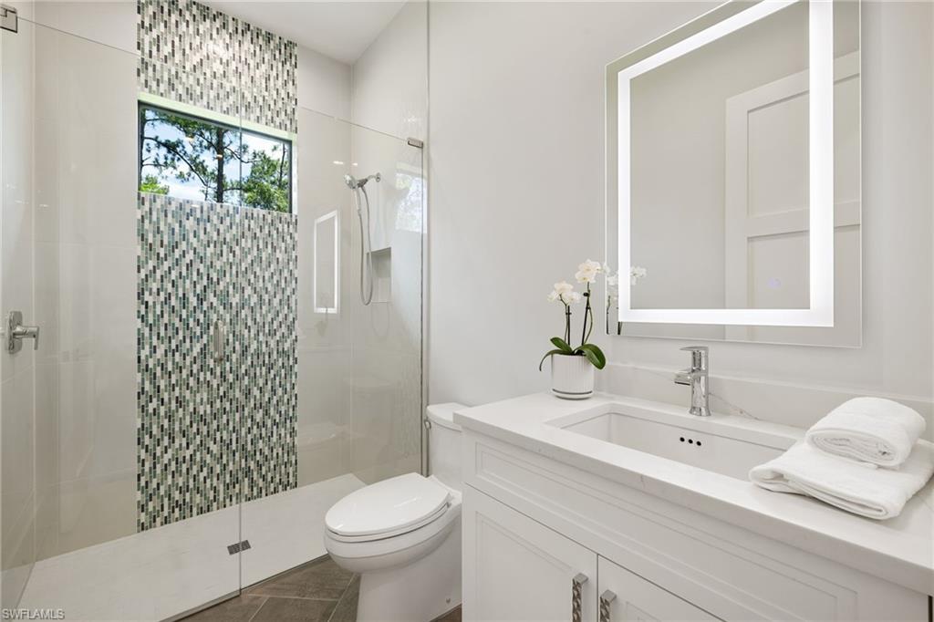 4751 1st Avenue Southwest Naples, FL 34119 - Photo 30 of 36 a bathroom with a sink a toilet and shower