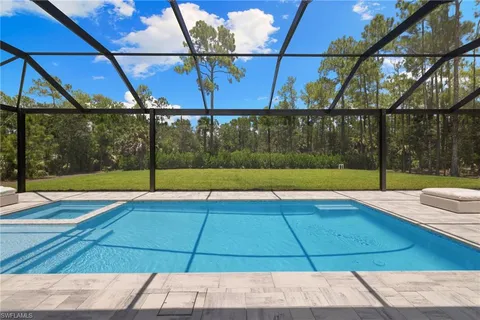 a front view of house with swimming pool and porch with furniture