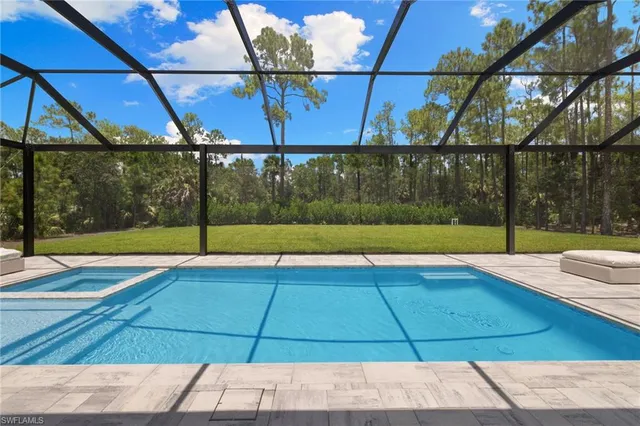 a front view of house with swimming pool and porch with furniture
