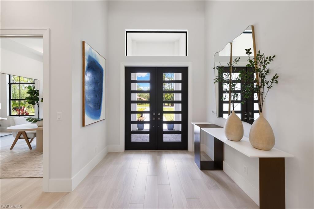 4751 1st Avenue Southwest Naples, FL 34119 - Photo 7 of 36 a view of entryway and hall with wooden floor