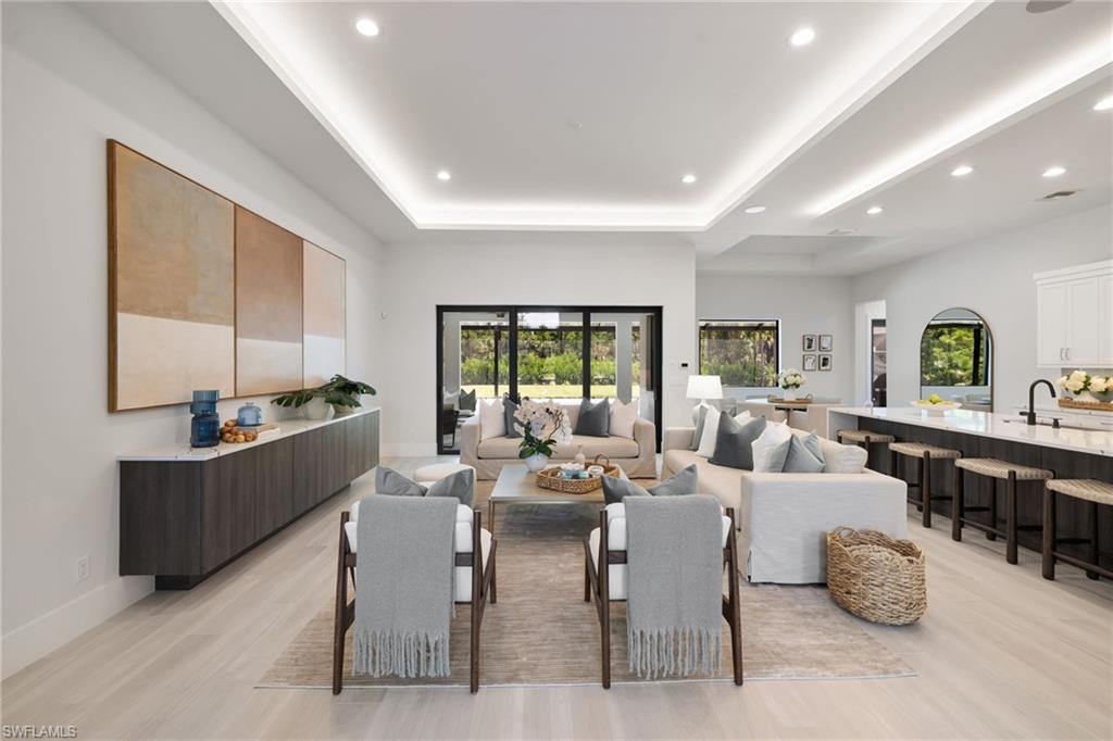 4751 1st Avenue Southwest Naples, FL 34119 - Photo 8 of 36 a living room with furniture kitchen view and a large window