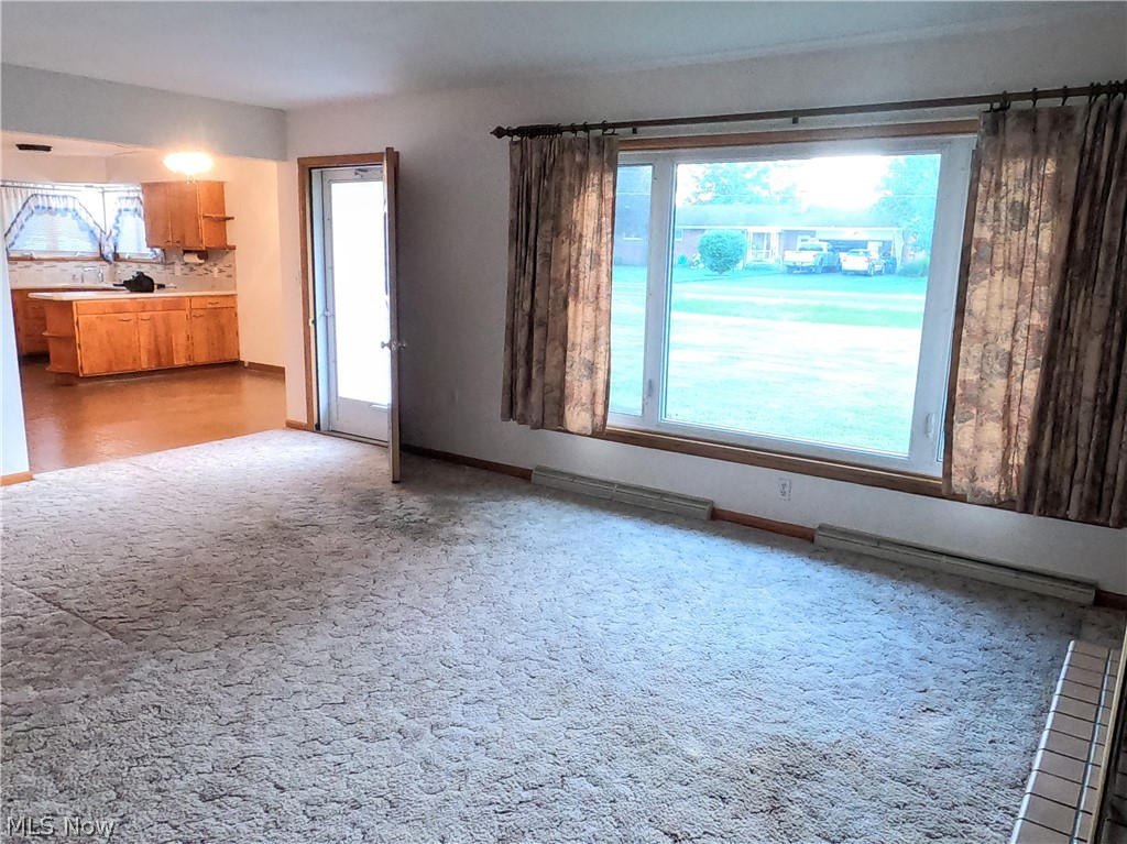 2586 Batdorf Road Wooster, OH 44691 - Photo 4 of 33 Unfurnished living room with a healthy amount of sunlight and carpet flooring