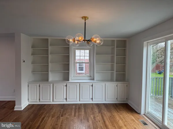 a view of wooden floor and windows in a room