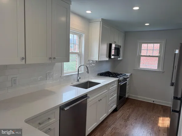 a kitchen that has a sink and a stove in it