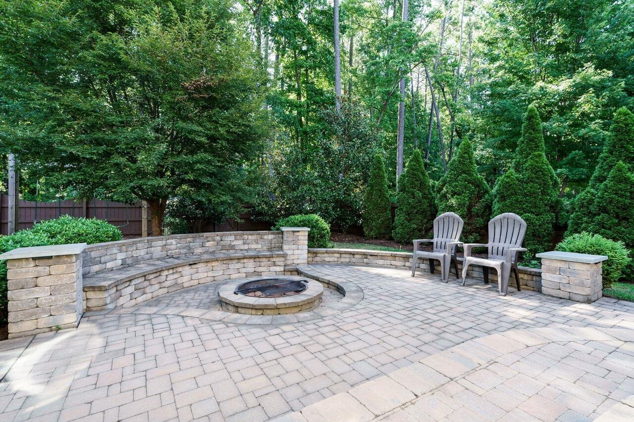 3003 Red Grape Drive Raleigh, NC 27607 - Photo 32 of 35 Fenced yard with paver patio and fire pit make this backyard beautiful and easy to enjoy everyday! Backyard