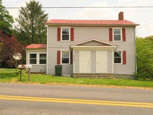 4113 Spring Hill Road Staunton, VA 24401 - Photo 1 of 49 a front view of a house with a garden and yard