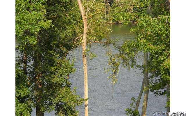 128 Lighthouse Road Mount Holly, NC 28120 - Photo 15 of 16 a view of a lake with a house