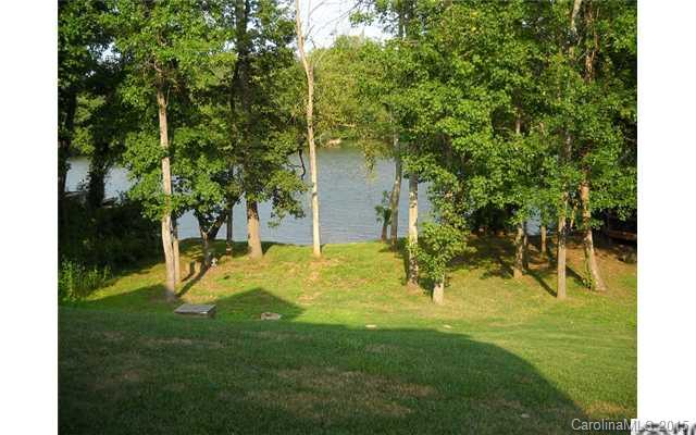 128 Lighthouse Road Mount Holly, NC 28120 - Photo 16 of 16 a view of a backyard with a small cabin