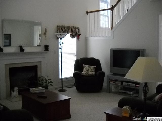 128 Lighthouse Road Mount Holly, NC 28120 - Photo 3 of 16 a living room with furniture and a fireplace