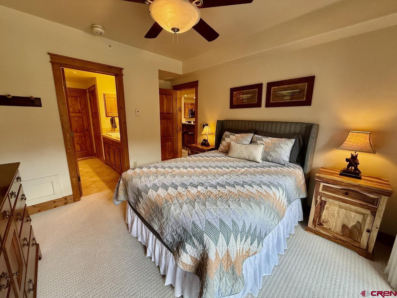 9 Hunter Hill Road, Unit 205 Crested Butte, CO 81225 - Photo 15 of 28 a bedroom with a bed and a chandelier