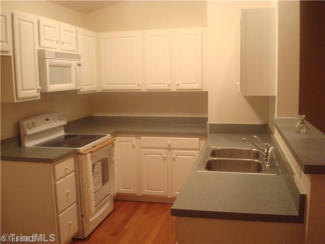 125 James High Point, Unit 3A High Point, NC 27265 - Photo 6 of 14 Kitchen. All appliances remain including refrigerator, washer and dryer.