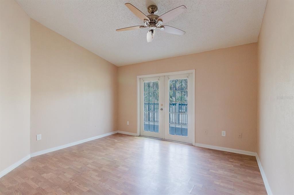 7804 Wilmar Court Port Richey, FL 34668 - Photo 19 of 82 wooden floor in an empty room with a window
