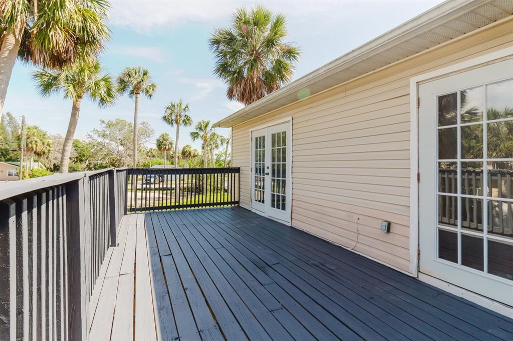 7804 Wilmar Court Port Richey, FL 34668 - Photo 26 of 82 a view of a wooden balcony with a garden