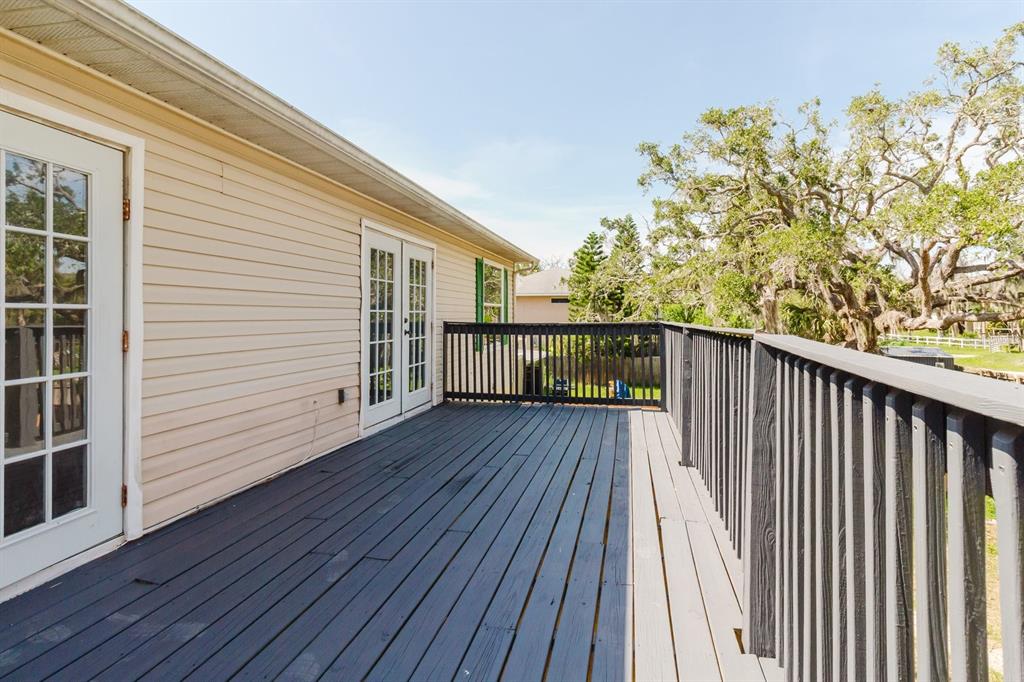 7804 Wilmar Court Port Richey, FL 34668 - Photo 27 of 82 a view of balcony with wooden floor and fence