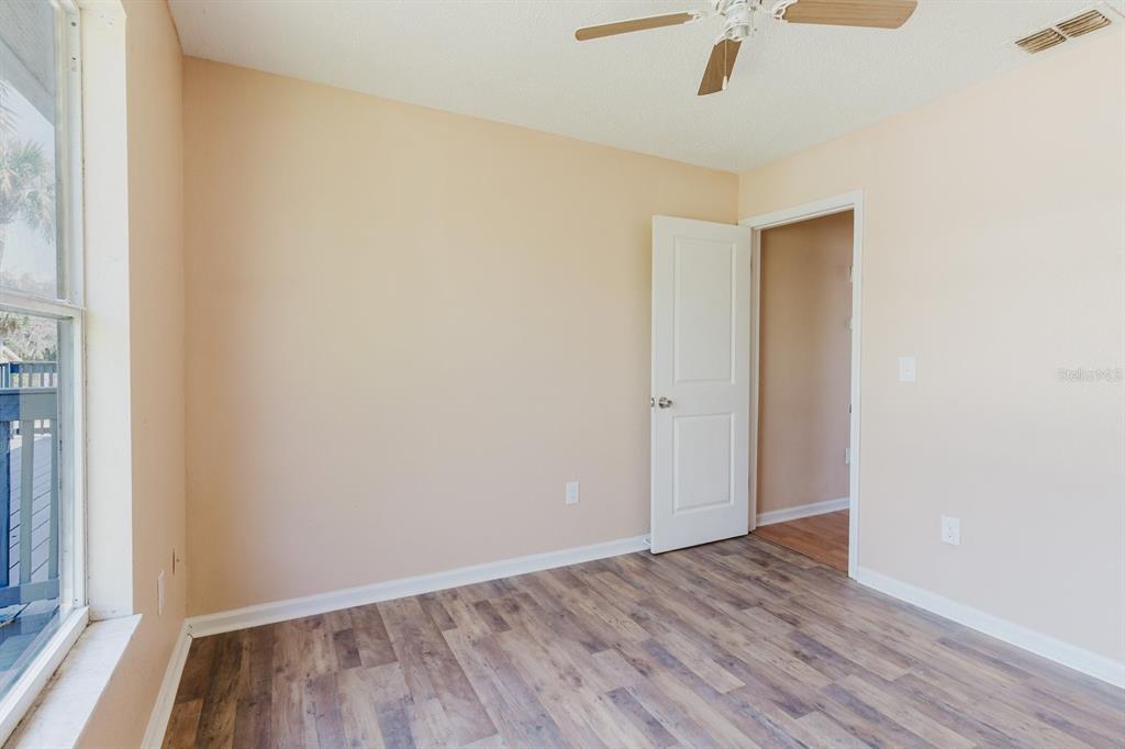 7804 Wilmar Court Port Richey, FL 34668 - Photo 30 of 82 an empty room with wooden floor and windows