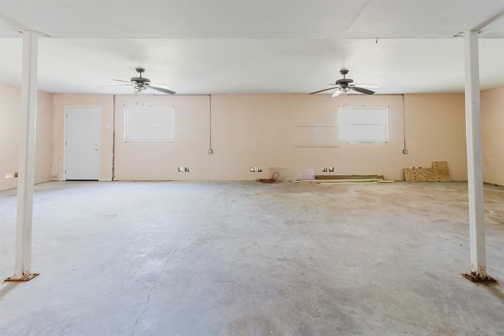 7804 Wilmar Court Port Richey, FL 34668 - Photo 36 of 82 an empty room with a ceiling fan and carpet