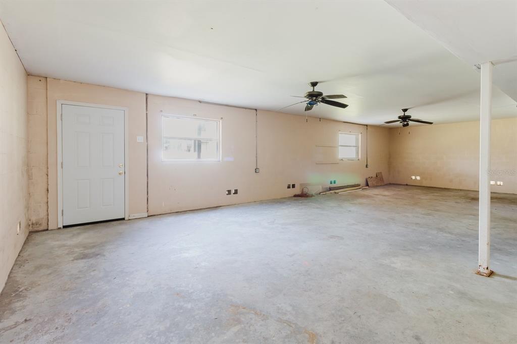 7804 Wilmar Court Port Richey, FL 34668 - Photo 40 of 82 an empty room with ceiling fan and windows
