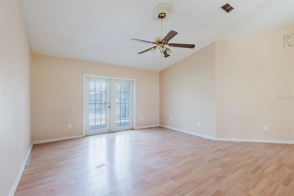 7804 Wilmar Court Port Richey, FL 34668 - Photo 4 of 82 a view of room with hardwood floor and ceiling fan
