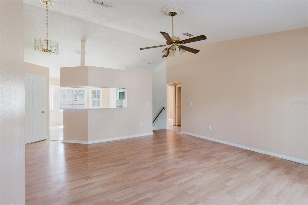 7804 Wilmar Court Port Richey, FL 34668 - Photo 6 of 82 a view of a room with wooden floor closet and a ceiling fan