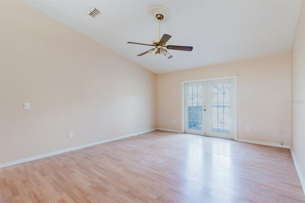 7804 Wilmar Court Port Richey, FL 34668 - Photo 7 of 82 wooden floor in an empty room with a window