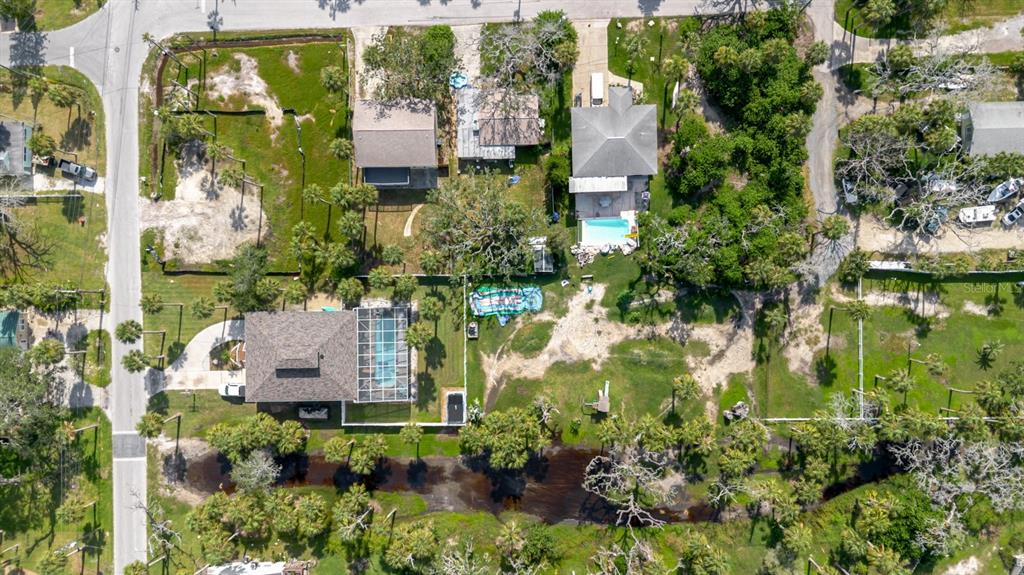 7804 Wilmar Court Port Richey, FL 34668 - Photo 76 of 82 an aerial view of residential houses with outdoor space and trees