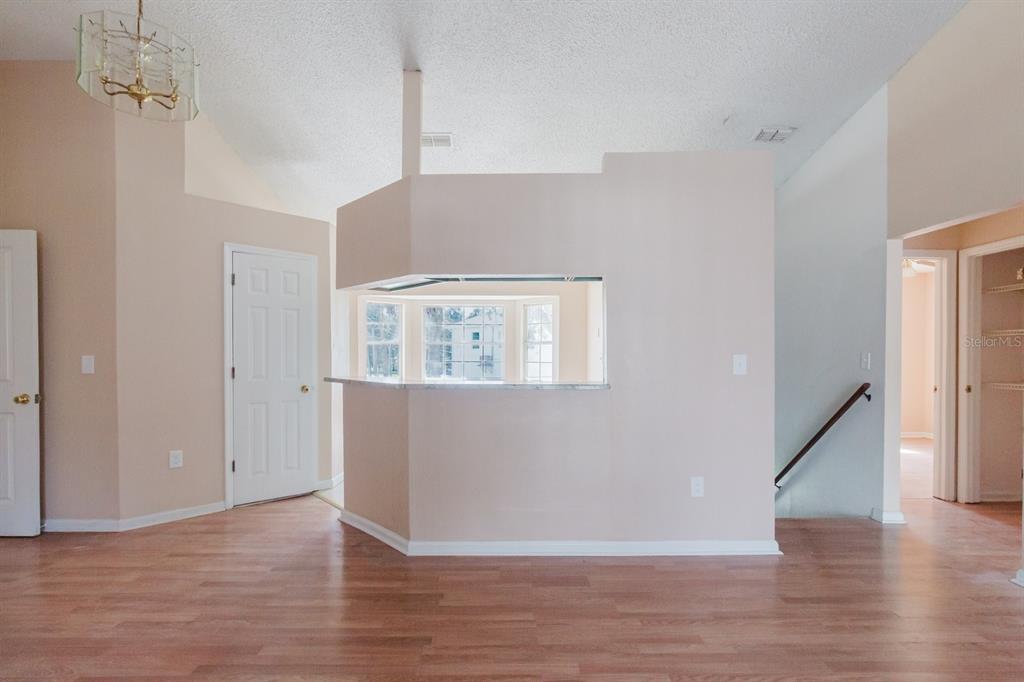 7804 Wilmar Court Port Richey, FL 34668 - Photo 8 of 82 a view of an empty room with wooden floor and a window