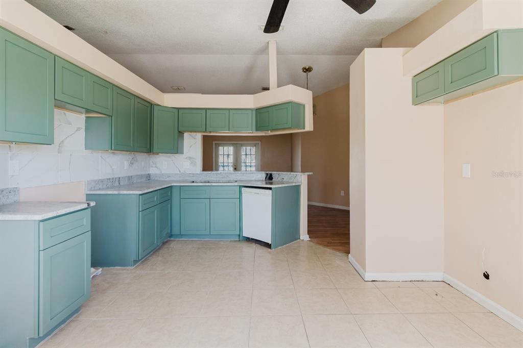 7804 Wilmar Court Port Richey, FL 34668 - Photo 10 of 82 a kitchen with a sink a cabinets and window