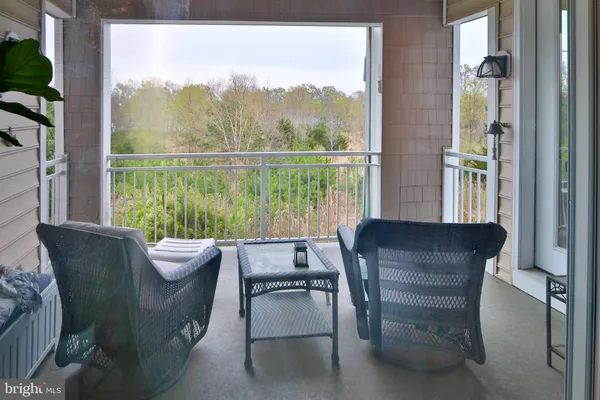 a view of a chairs and table in a balcony